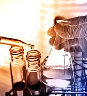 Image of a Chemist handling flask and test tubes