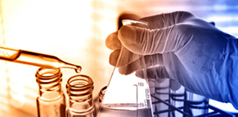 Image of a Chemist handling flask and test tubes